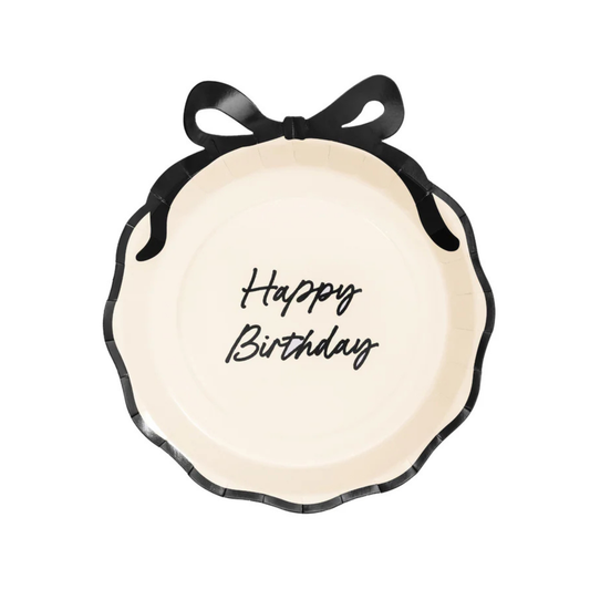 Cream paper plate with scalloped edges, black bow detail, and “Happy Birthday” script.