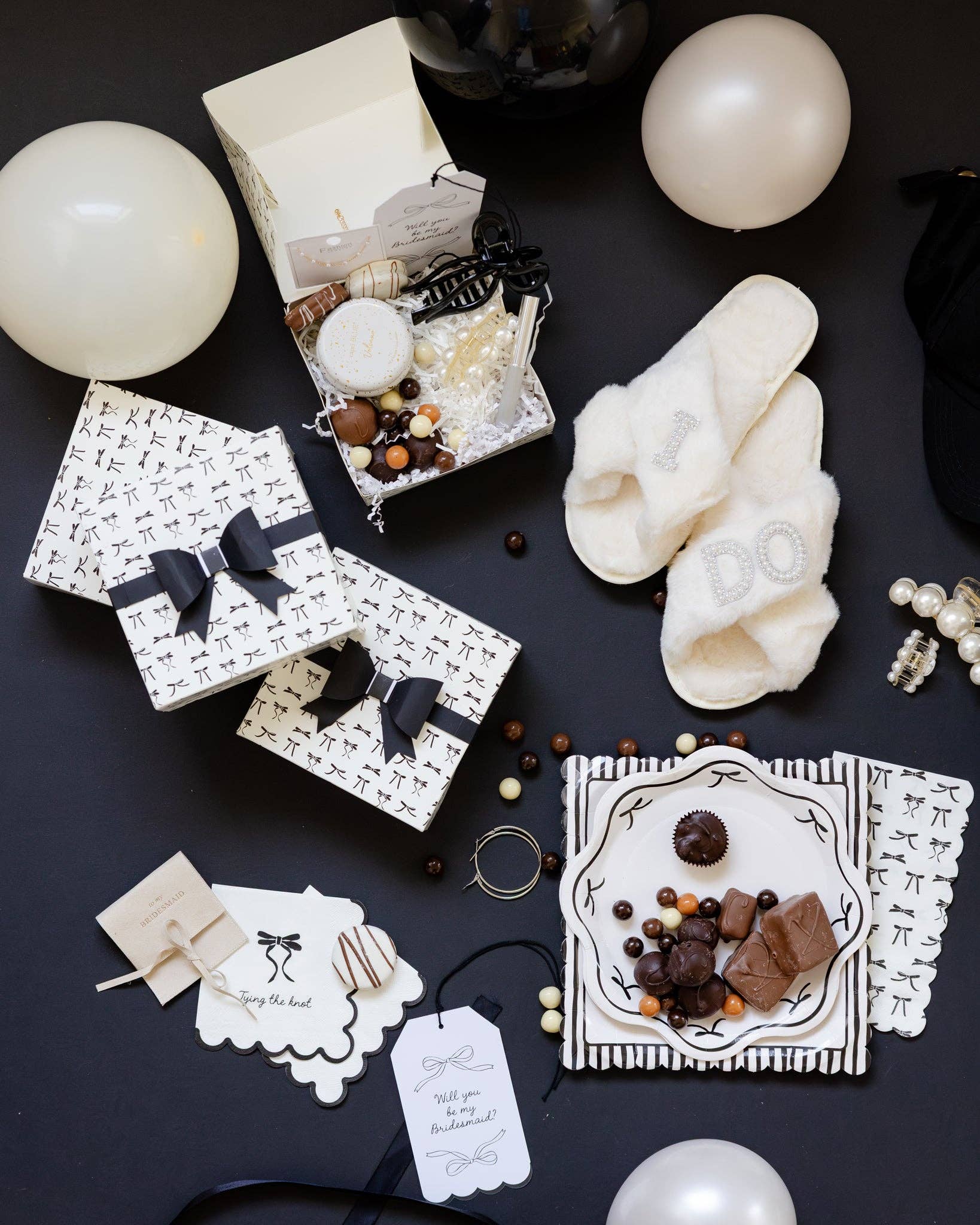 Elegant bridal table featuring black bow napkins, plates, and themed décor - perfect for showers or engagement parties, shipping across Canada.