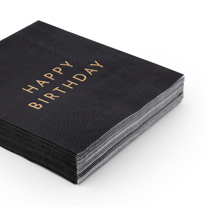 Stack of black Happy Birthday cocktail napkins with gold foil lettering and embossed detail