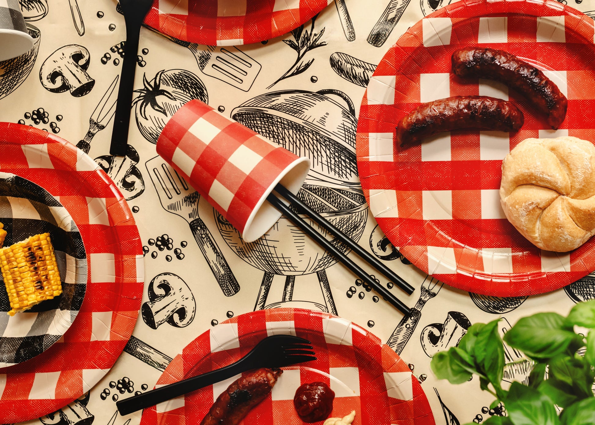 Party table with black reusable straws and red checkered tableware available in Toronto and shipping across Canada