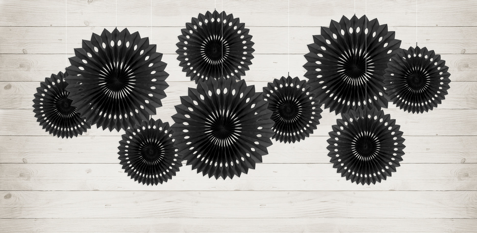 Black rosette backdrop decor arranged on a wall available at our Toronto party shop