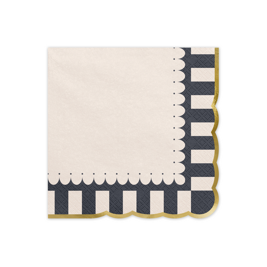 Folded paper napkin with black and white stripes, scalloped edge, and shiny gold border.