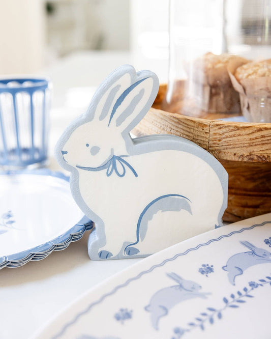 Blue bunny shaped napkins styled on an Easter table with coordinating blue plates and spring décor, available in Toronto