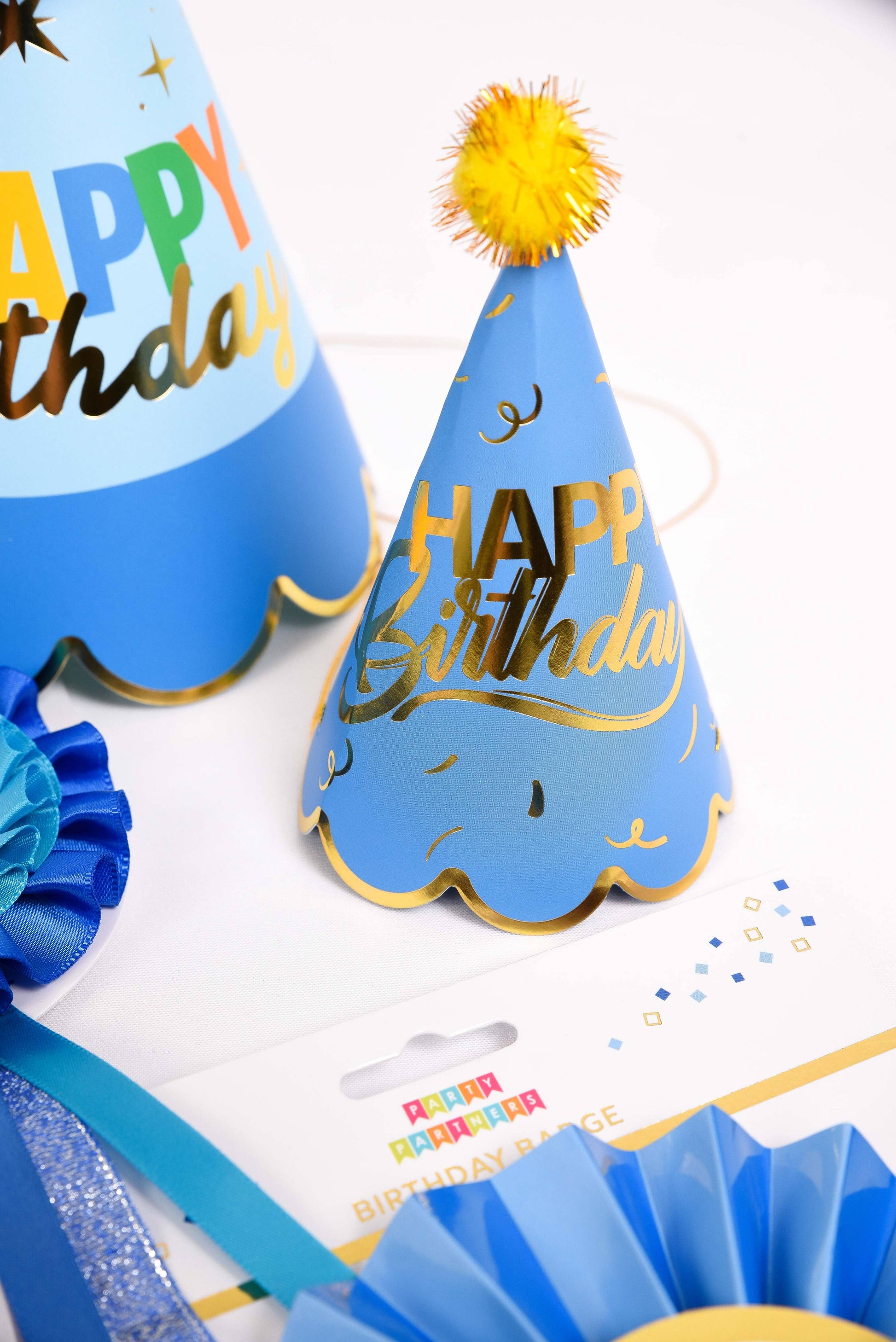 Blue birthday party hats with 'Happy Birthday' text on a white background