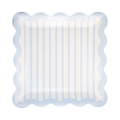 Decorative plate with scalloped edge and blue and white striped pattern on a white background