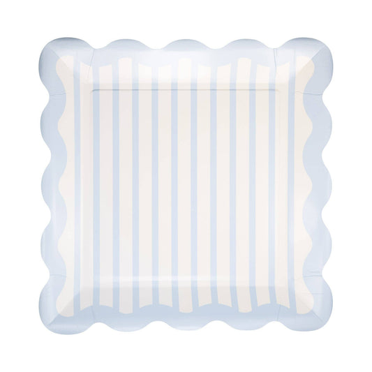 Decorative plate with scalloped edge and blue and white striped pattern on a white background