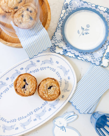 Blue striped dinner napkins styled with Easter tableware and spring desserts, sold at Confetti My Party Toronto