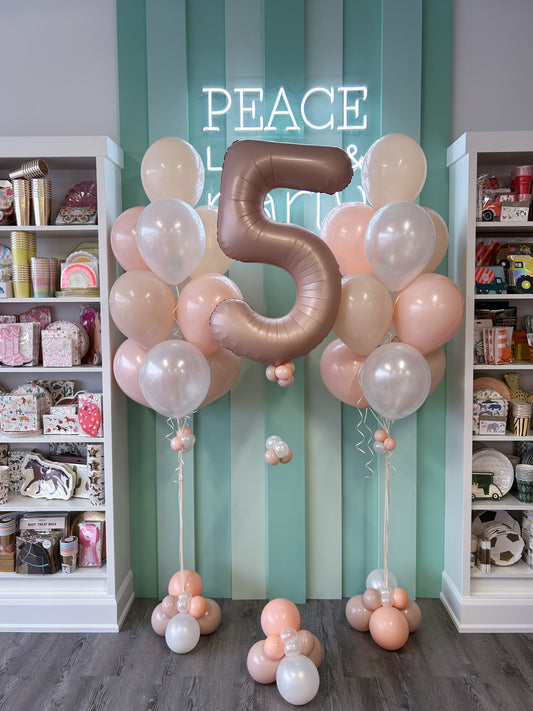Blush birthday balloon bundle with custom satin number balloon and coordinating pink and pearl helium bouquets available at our Toronto balloon shop