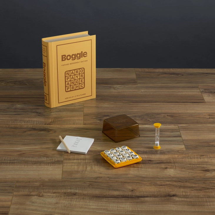 Boggle game set on a wooden table with a dark background