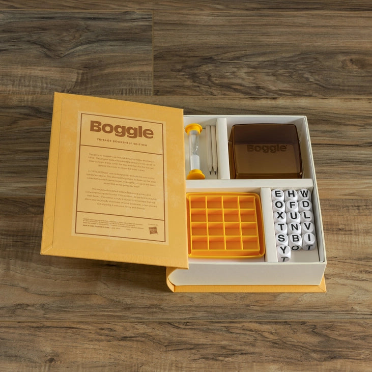 Boggle game set with packaging on a wooden surface