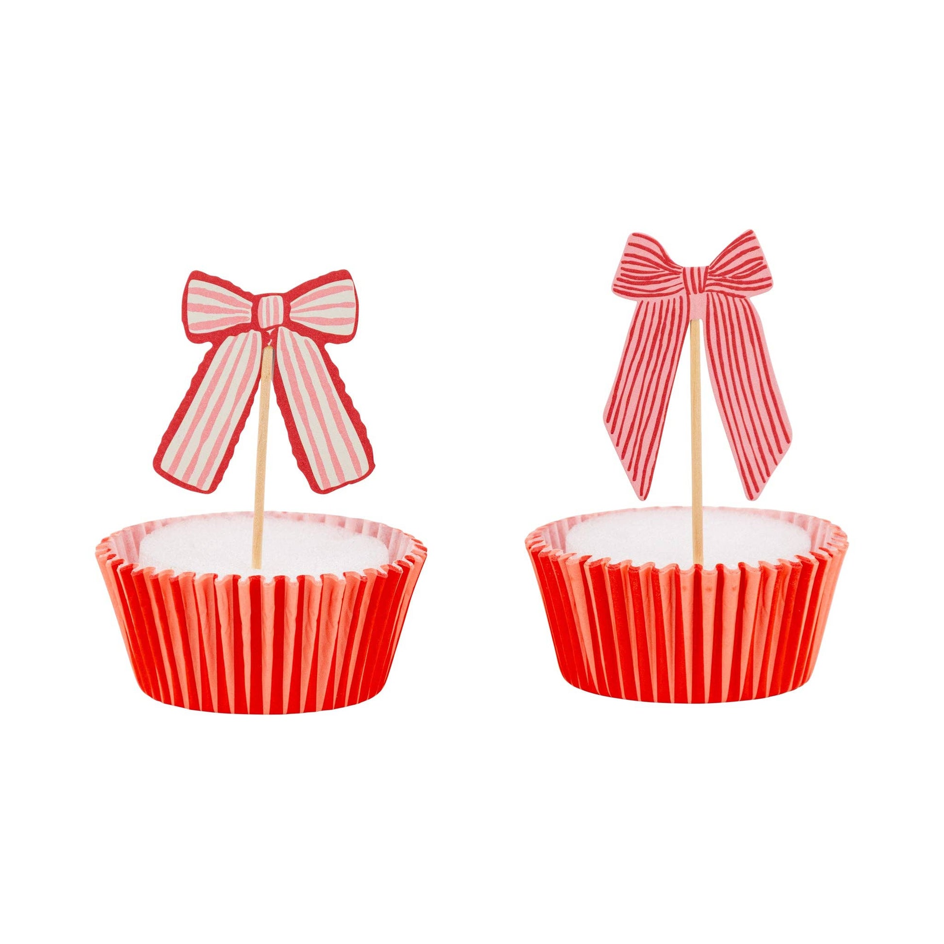 Cupcake topped with a decorative pink bow topper and striped liner, available in Toronto at Confetti My Party