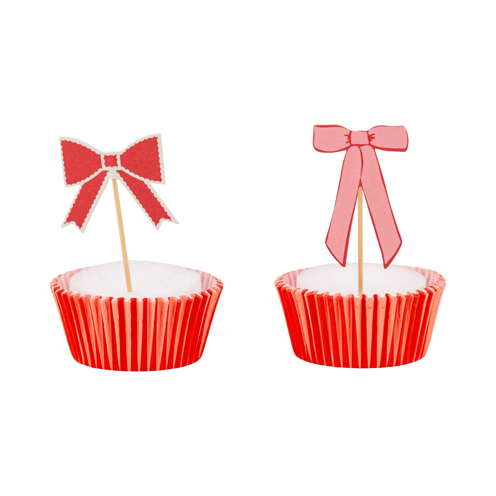 Assorted pink and red bow cupcake toppers displayed on cupcakes, sold in Toronto at Confetti My Party 