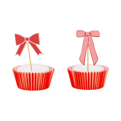 Assorted pink and red bow cupcake toppers displayed on cupcakes, sold in Toronto at Confetti My Party 