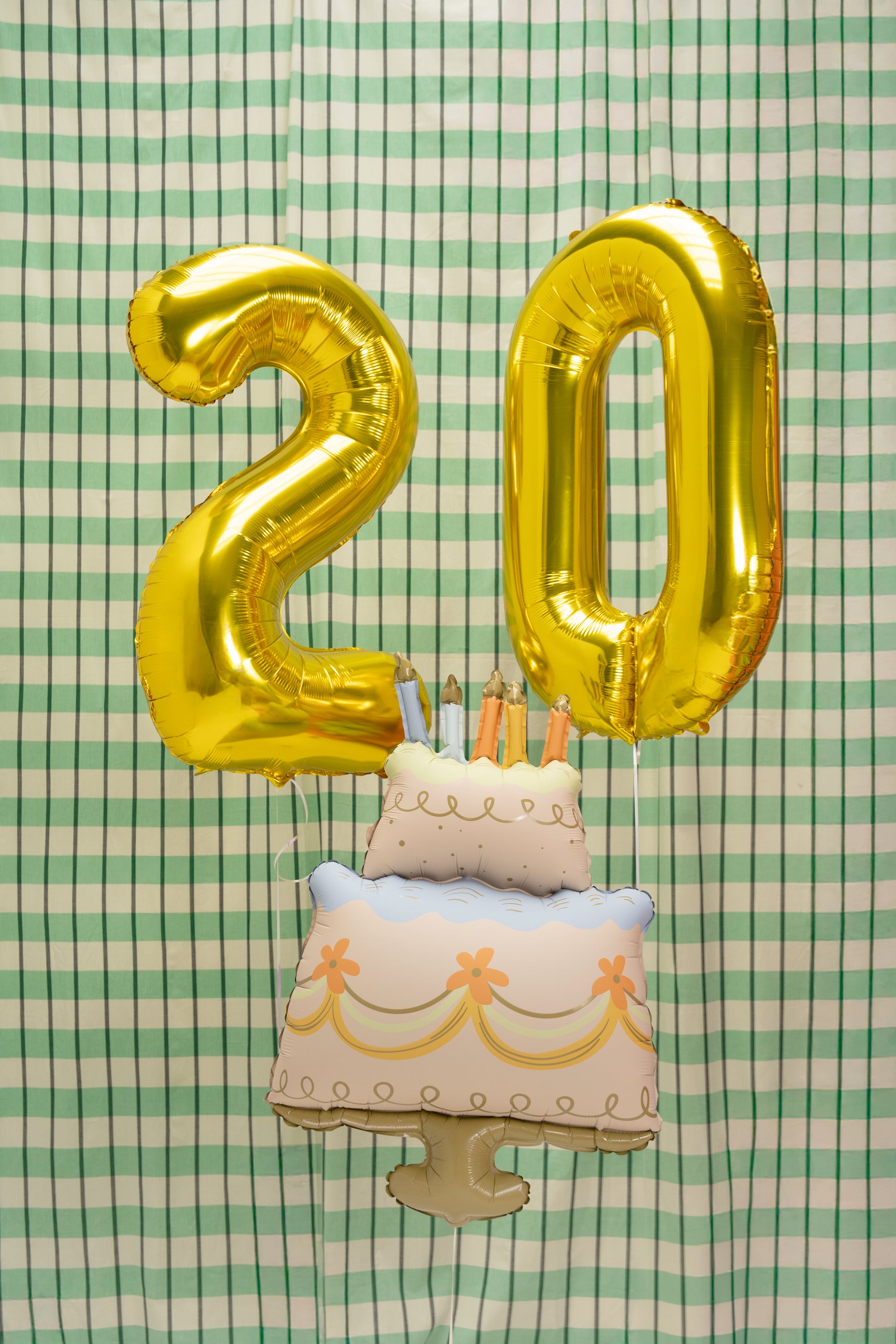 Gold number balloons with cake-shaped foil balloon for birthday celebrations in Toronto.