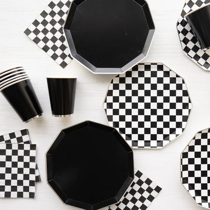 Modern black and white checkerboard party table with plates, cups and napkins, available at our Toronto party shop