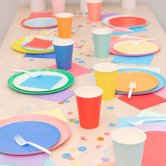 Cherry red dessert plates styled on a colourful party table with cups and confetti, available at Confetti My Party in Toronto