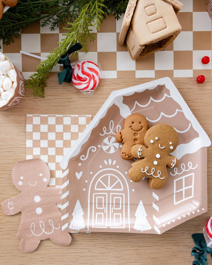 Gingerbread girl napkins styled with gingerbread house plates and cookies, available in Toronto and shipping across Canada.