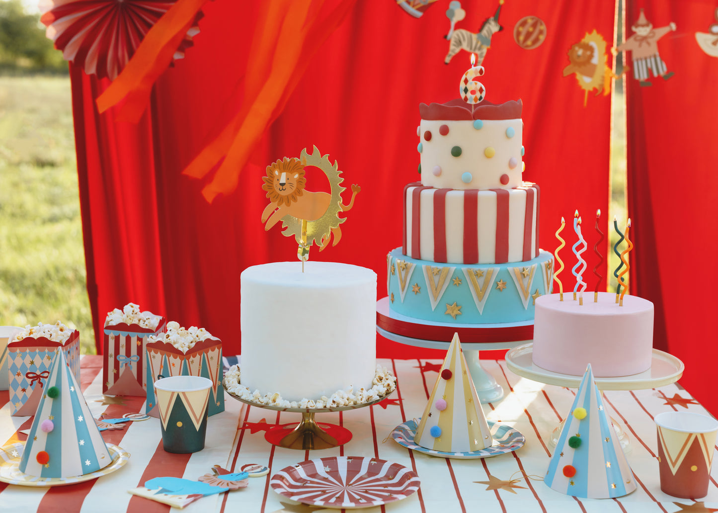 Rainbow curl birthday candles styled on colourful circus themed party cakes available at our Toronto party shop