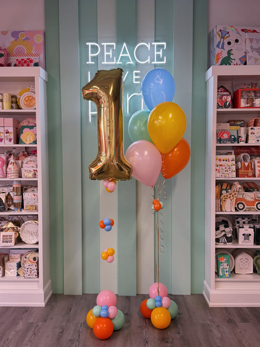 birthday balloons with a white gold foil number and colourful balloon bundle