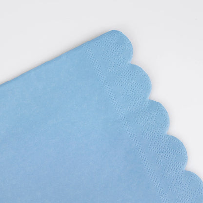 closeup of scalloped edge on blue cocktail napkin