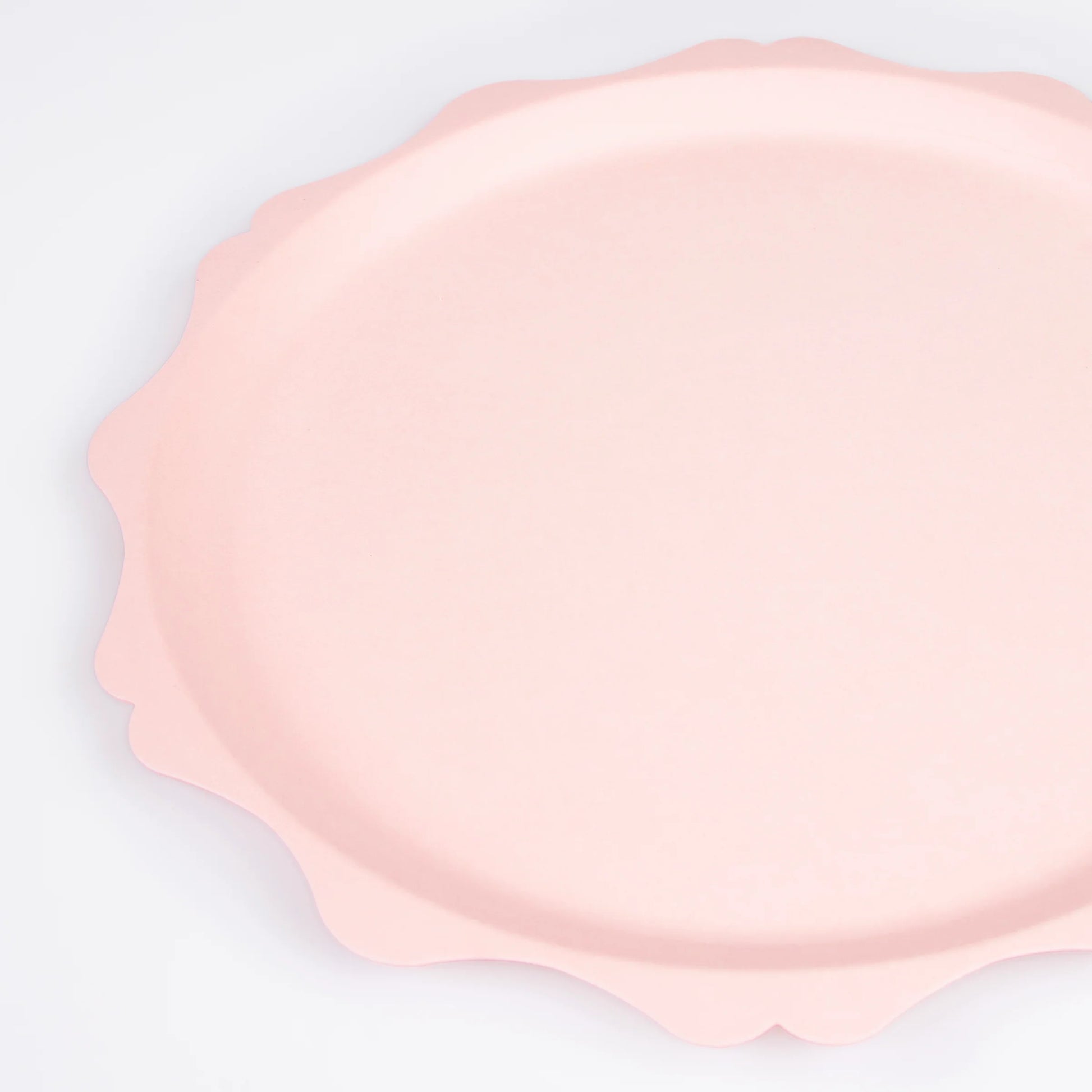 closeup of pink dinner plate with scalloped edge