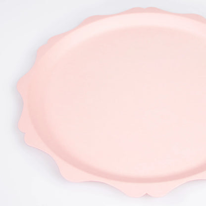 closeup of pink dinner plate with scalloped edge