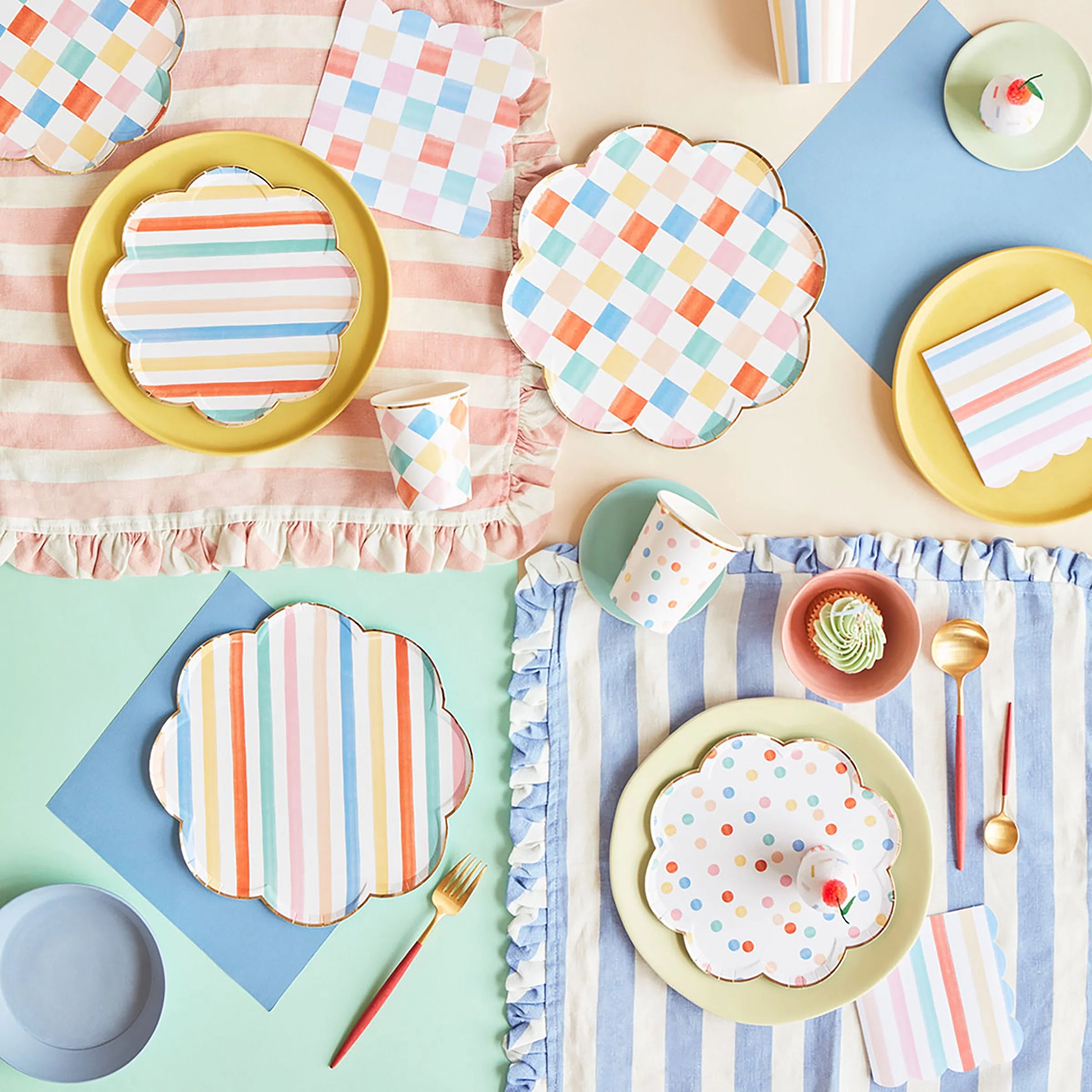 Meri Meri colourful scalloped dinner plates styled on a pastel party table with striped napkins and gold cutlery, available at our Toronto party shop