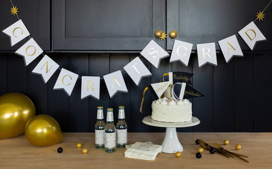 Congrats Grad banner styled for a graduation party table, available in Toronto at Confetti My Party