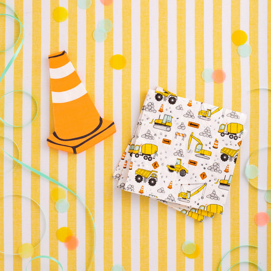 Construction-themed dinner napkins with yellow trucks and roadwork icons styled for a kids construction birthday party from My Minds Eye, sold at Confetti My Party Toronto