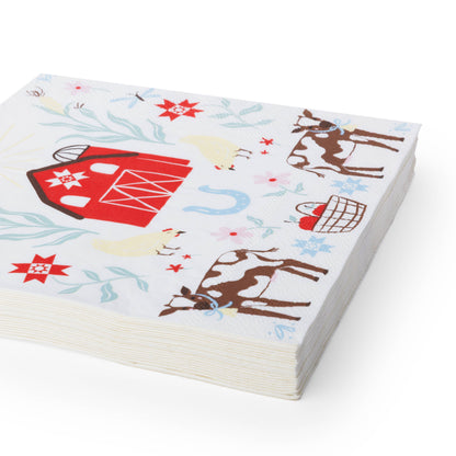 Stack of countryside farm animal large napkins featuring cows, chickens and a bright red barn.