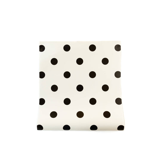 White paper table runner with black polka dots on a white background