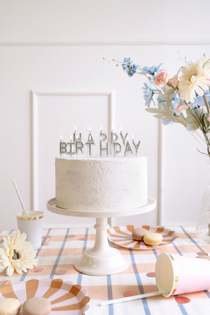 Silver Happy Birthday candles styled on a birthday cake available at our Toronto party shop