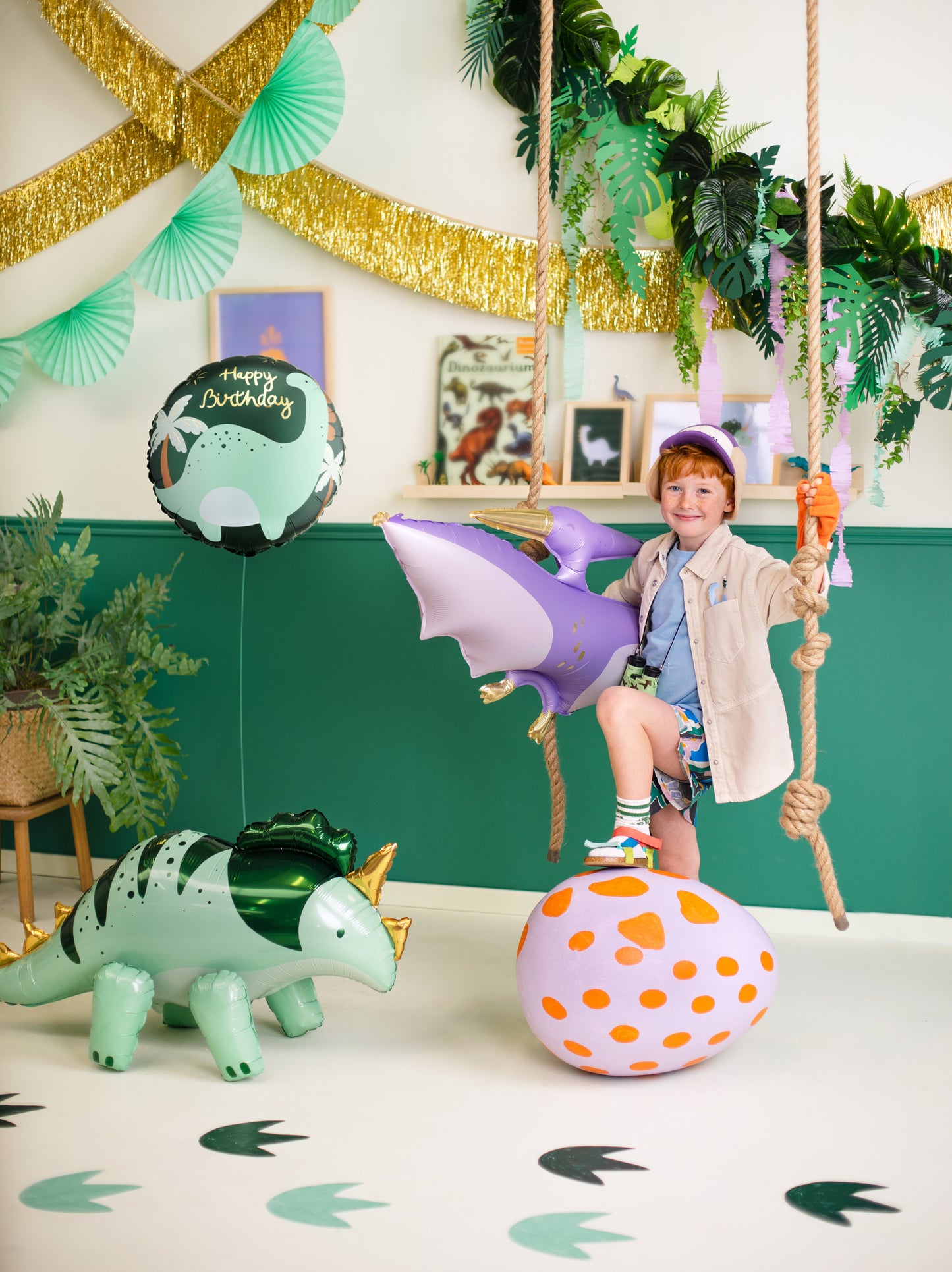 Dinosaur birthday party setup with matching dinosaur foil balloon available in Toronto and shipping across Canada