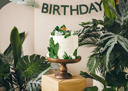Dinosaur birthday candles styled on a jungle-themed birthday cake available in Toronto and shipping across Canada
