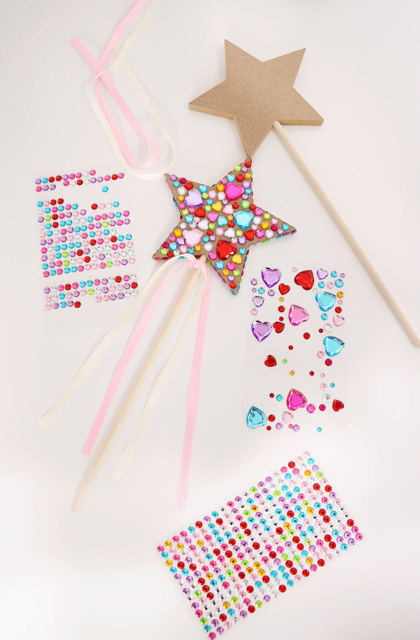 Set of 3 wood star-shaped wands with decorative beads on a white background