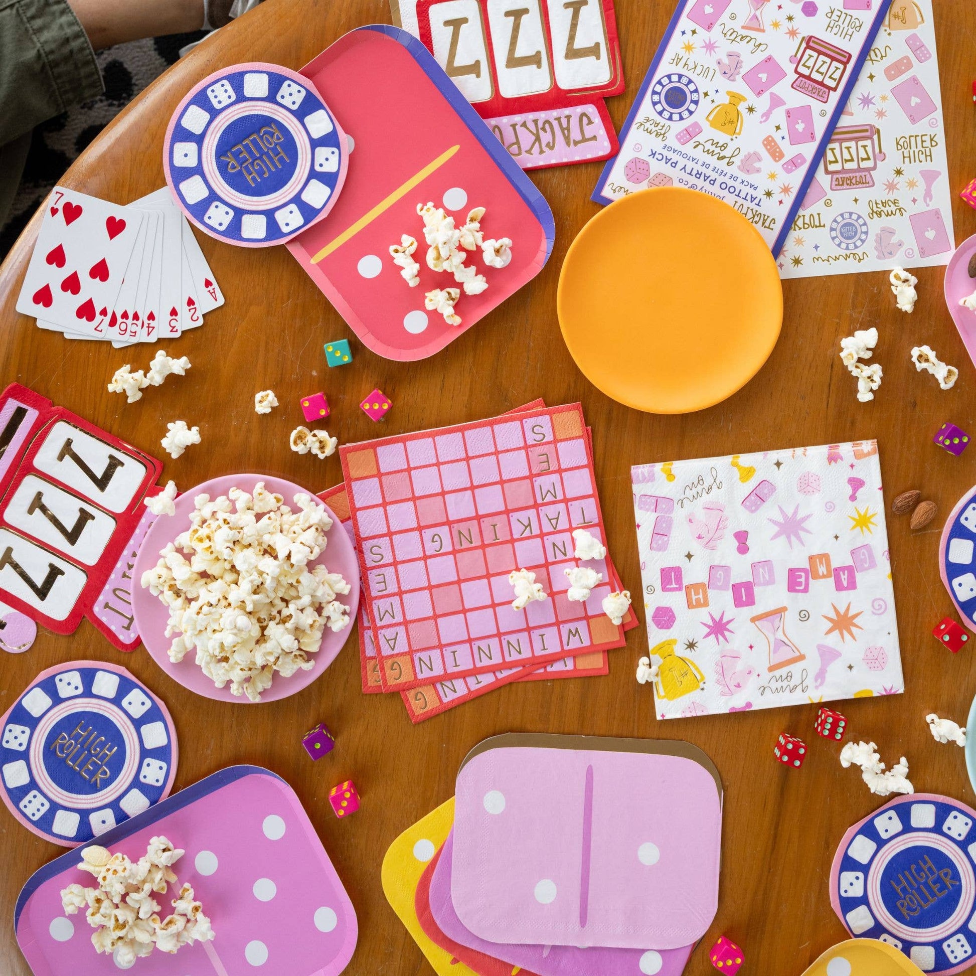 able setup with Dominoes plates, Game Night napkins, and popcorn for a playful themed party, shipping across Canada