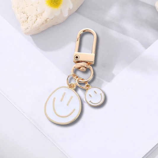gold keychain with double happy face in white
