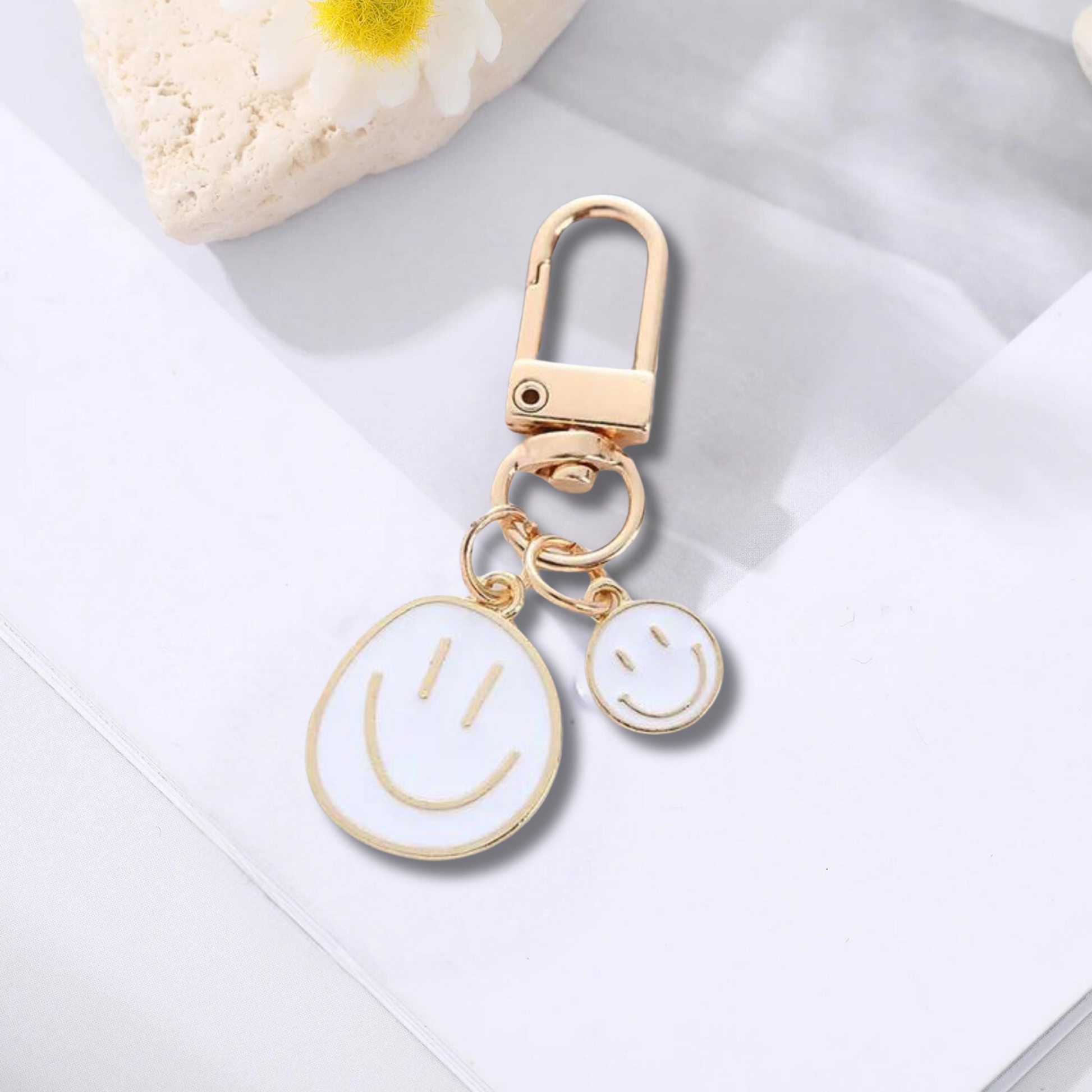 gold keychain with double happy face in white