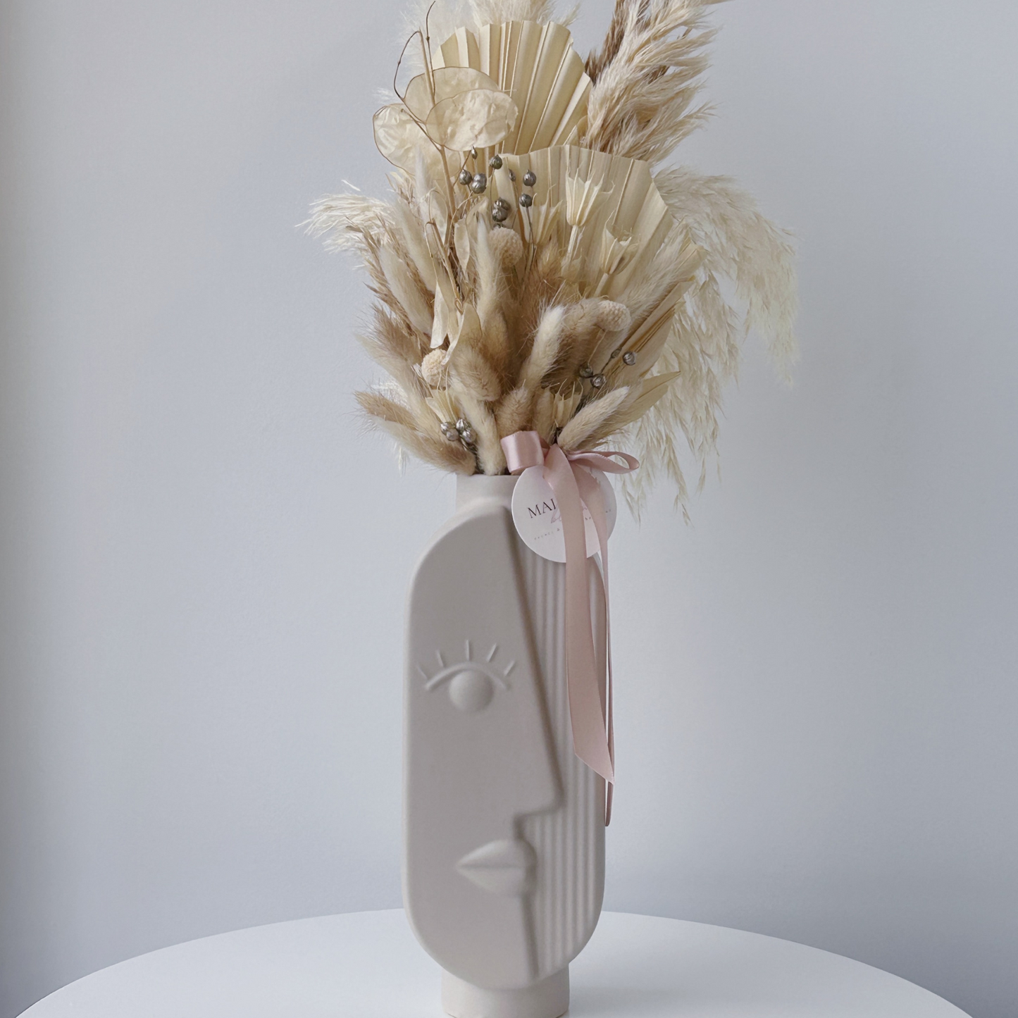 taupe girl vase dried floral arrangement 