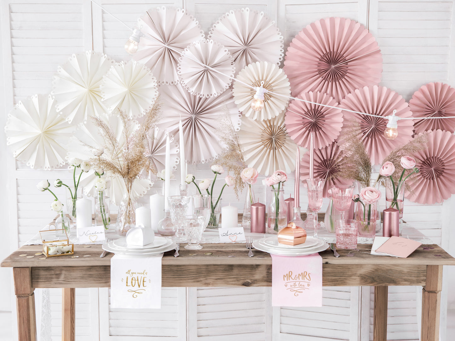 Set of dusty rose paper rosettes in three sizes available at our Toronto party shop