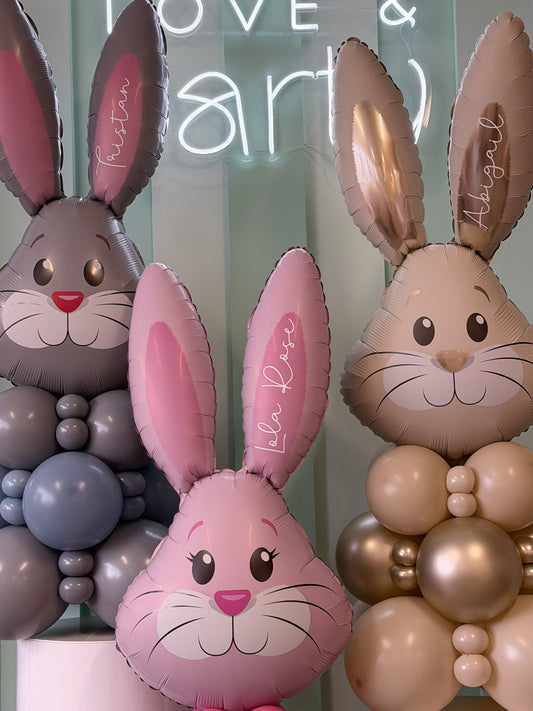 Close-up of Easter bunny balloons with custom name personalization in soft pastel colours, available at our Toronto party shop