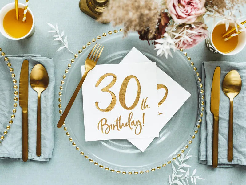 Elegant table setting with white and gold 30th birthday napkins, shipping Canada-wide.