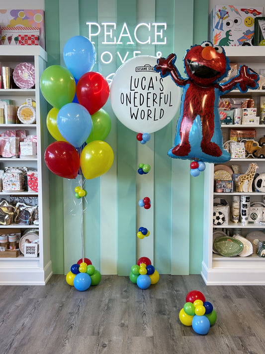 Elmo’s World balloon bundle featuring an Elmo foil balloon and personalized jumbo balloon with bright red, blue, yellow, and green balloons, sold in Toronto at Confetti My Party