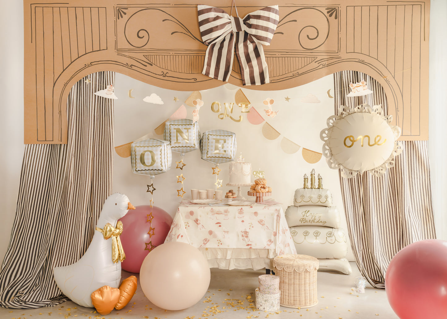 Standing goose foil balloon styled in a neutral first birthday setup with bow decor and cake table, available at our Toronto party shop.