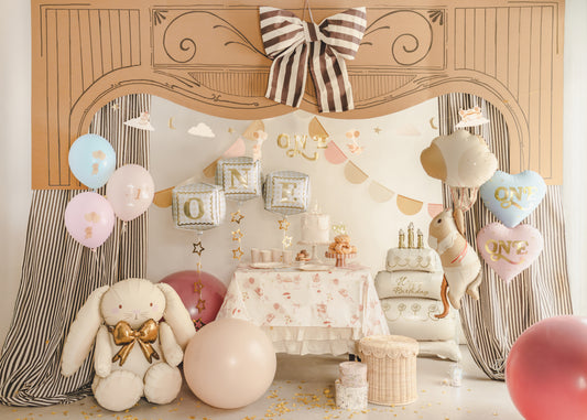 First birthday party setup with “ONE” cube balloons, bow decor, and soft neutral styling, available at our Toronto party shop.