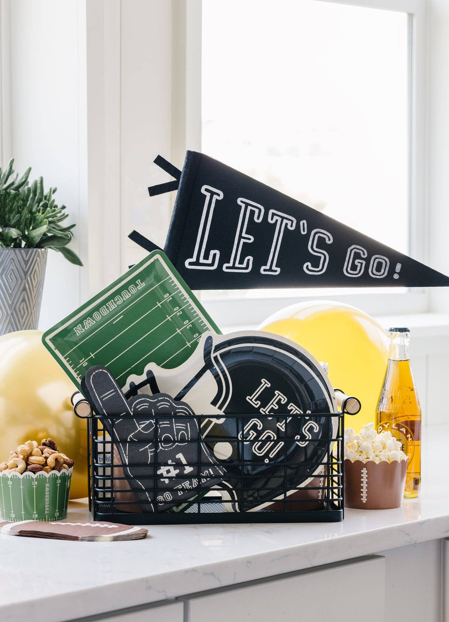 Game day party setup with football field plates, helmet plates, and themed decor for Toronto celebrations.