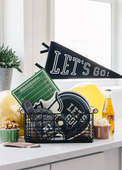 Game day party setup with football field plates, helmet plates, and themed decor for Toronto celebrations.