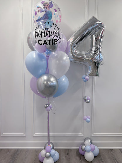 Full Frozen Elsa birthday balloon bouquet with a personalized bubble balloon, silver number 4, Elsa character balloon, pastel purple, pastel blue and silver latex balloons and decorative balloon bases.