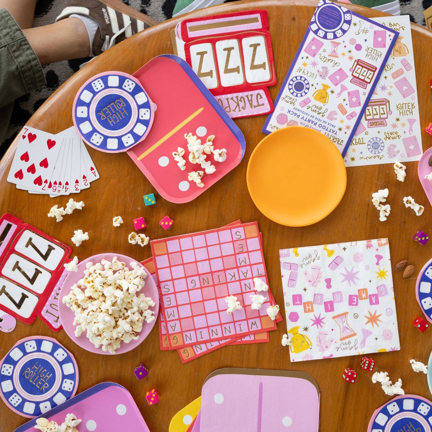 Game night table setup featuring Jackpot napkins, popcorn, dice, and bright retro tableware, available in Toronto and shipping across Canada.