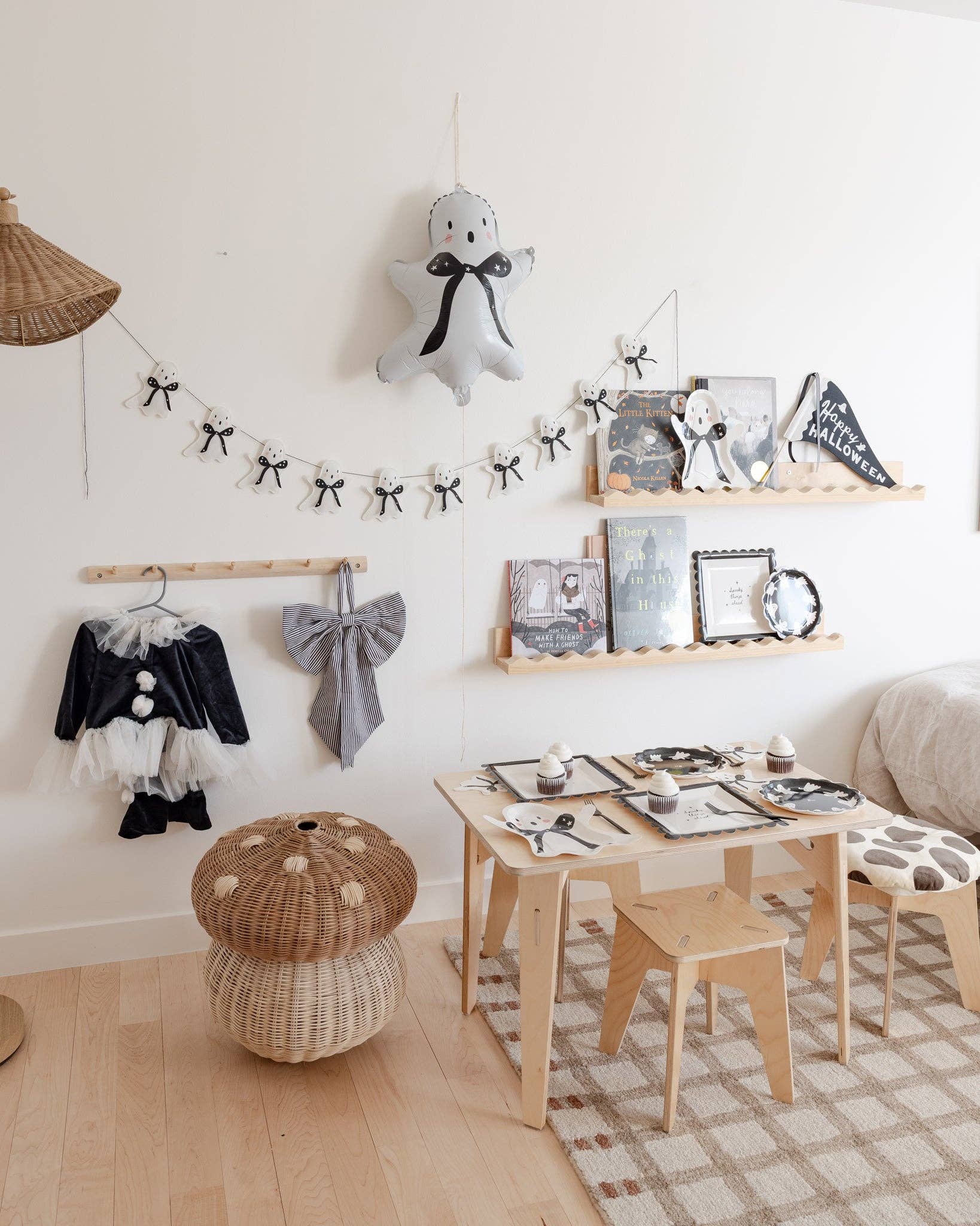 White ghost felt banner displayed as Halloween wall decor in a kids party setup